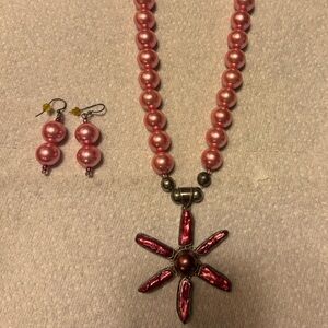 Pink pearl necklace and matching earrings.